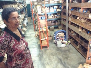 Mrs. Majid standing next to the tumbled area in the shop where her husband’s body was found