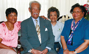 MILESTONE: John Henry Dillon celebrates his 105th birthday surrounded by three of his four daughters [from left) Cora, Ruth and Sonita.