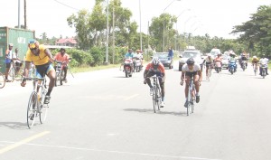 Warren Mc Kay (left) approaches the finish ahead of Christopher Holder (right) and Albert Philander (centre) yesterday. (Franklin Wilson photo)