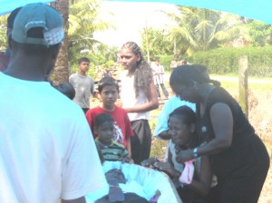  The grieving wife of Mahendra Seenarine being consoled by relatives yesterday at the funeral service. 