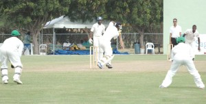 Dwayne Smith covers up to Bess  during his 80 against Guyana