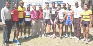 The top performers at the Forbes Burnham 85th birth anniversary 36 mile road race pose with Mayor Hamilton Green (5th left), Vincent Alexander (2nd right) and President of the Guyana Cycling Federation Hector Edwards (left) following the presentation of prizes.