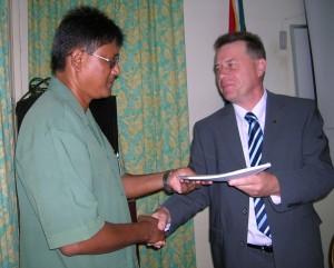  WWF Regional Representative, Dominiek Pouvier (right) hands over a copy of the agreement to Commissioner of the Guyana Forestry Commission, James Singh. 