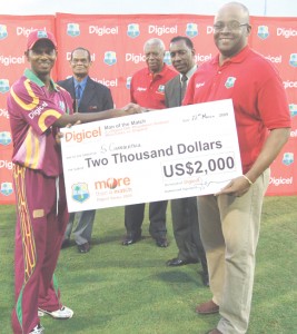 Shivnarine Chanderpaul collects the man-of-the-match prize from Digicel’s Donovan White yesterday. (Franklin Wilson photo) 