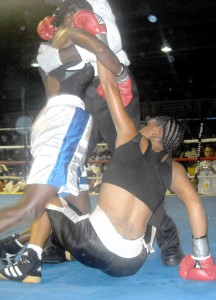 The action between Shaundel Alfred  (on ground) and Stephney George was furious  as depicted in this photo, the referee having his hands full to separate the pair despite a slip to the canvas by eventual winner Alfred.