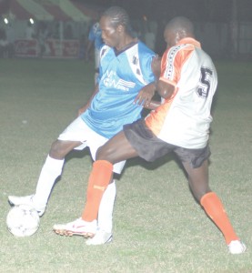 Camptown’s Anthony Belfield (No. 5) in a battle for possession with Flamingo’s Dwayne Layne on Monday evening at the Tucville ground. (Franklin Wilson photo) 