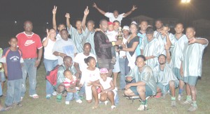 Captain of Central Simon Lynch (left) collects the winning trophy from Miss Bartica Regatta 2008 Queen, Feanio Richards. (Franklin Wilson photo) 