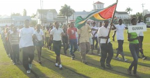 GETTING IT RIGHT! Guyana's IGG contingent, including the track and field athletes,  participate in a 'March–Pass' rehearsal at the Police Sports Club Ground, Eve Leary yesterday.