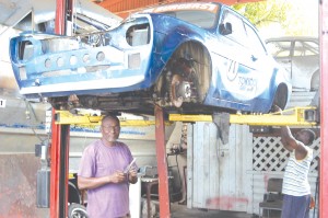 The experienced Barbadian Freddie Mapp seen working on Jad's car yesterday.