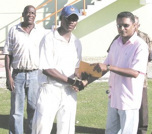 Twenty-three-year-old Bajan Kevin Stoute, who finished the competition with 604 runs and 22 wickets from nine matches, collects his Man-of-the-Match award from Guyana Cricket Board Secretary Anand Sanasie.  