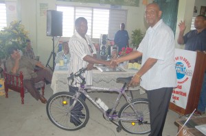 Commander of ‘B’ Division George Vyphuis (right) receiving  the bicycle from President of the RHTY&SC Keith Foster. 