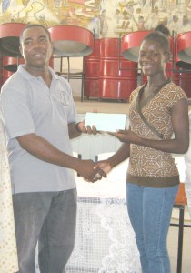 Jenella Jonas (right) receives the cash  donation from Chairman of the South  Georgetown District Branch, Kirwyn Mars.