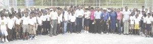 Director of Sport Neil Kumar (centre long-sleeved shirt) poses with participants shortly after declaring the Boys segment of the Al Sport/MCYS Windball Cricket Championships open yesterday. 