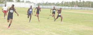 Chavez Ageday (left) sprints to victory in the U 17 100m dash.