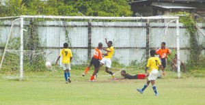 Fruta Conquerors' Brandon Joseph (2nd left) scores the first goal of a double  against Santos yesterday at the Tucville ground. (Franklin Wilson photo)