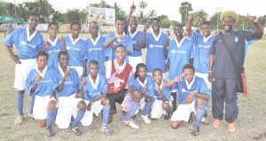 We are #1!!! The 2009 GFF Inter Association Under-15 champions Georgetown pose with their coach Sampson Gilbert after defeating East Coast 4-0 yesterday at the Tucville ground. (Franklin Wilson photo)