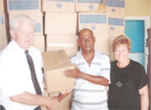  Elder Whitehead and Sister Whitehead handing over the items to member of the RHTYSC, Ravindra Kissoonlall (centre).