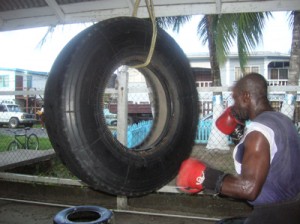 Mark Murray pounds away on the truck wheel, which is used for developing power in the arms