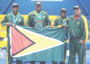 The successful Guyanese strongmen fly the Golden Arrowhead proudly.  From left: Randolph Morgan, ‘Big’ John Edwards, Mervin ‘Spongy’ Moses and Manager Peter Green.