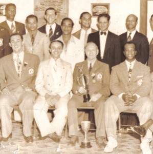 A young Sydney Paul (fourth left standing) poses with members of the country’s first Weightlifting Association -  in the 1940s. Front row (holding trophy) is Cyphius Whitney. (Photo courtesy of Sydney Paul)