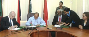 (From left) U.S. Bureau of Alcohol, Tobacco, Firearms and Explosives (ATF) Representative, David T. Johnson, Home Affairs Minister, Clement Rohee and US Ambassador John Jones, sign the MOU, in the presence of Foreign Affairs Minister Carolyn Rodrigues (right) and Director General, Ministry of Foreign Affairs, Elisabeth Harper (background).