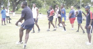 Head Coach Laurie Adonis (extreme right) supervises a session with the Under-19 squad yesterday, at the National Park.