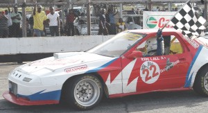 Flashback: US-based Guyanese Kem Lall takes the chequered flag after winning a race.