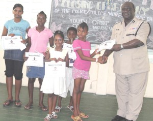 Police commissioner Henry Green personally hands over cash and certificates to the best campers to conclude the 2009 police youth camp. 