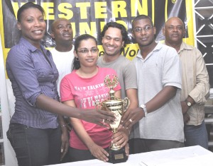 The victorious 3-member NCN team poses with the number one trophy along with Western Union Marketing Manager Natheeah King (left). Chief Steward George Griffith is standing at back right with coordinator Franklin Wilson to King’s left. 