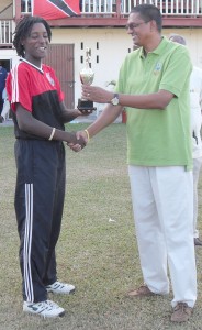  Britney Cooper (left) collects her player  of the match prize from GCB’s Ramsey Ali. 