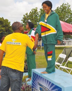 Soroya Simmons, 11-12 50m backstroke Gold medalist being congratulated by BASA VP Guyanese Volville Forshyte