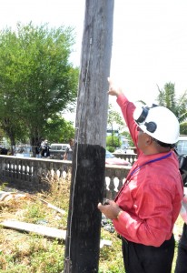 GPL’s Chief Executive Officer, Bharat Dindyal, inspecting a post in Kingston where vandals stole the copper earth wire  