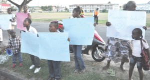 These children shout angrily during the protest yesterday.