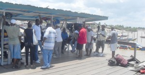  Boat operators speaking with reporters from Kaieteur News yesterday.