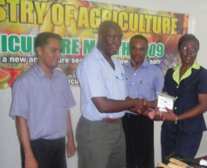 Hadassah Hammond (right) makes the Food for the Poor  presentation to Deputy Permanent Secretary, George Jarvis