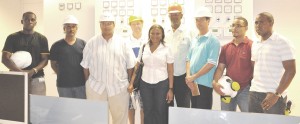 Chairman of GPL, Winston Brassington (third from left) along with a GPL team in the control room of the new Kingston Power Plant. 