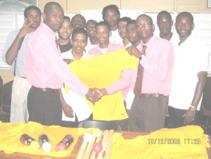 President of the NIS Sports Club, Ingram Lewis (left) hands over the jersey’s and cricket equipment on behalf of Denmore Garment Factory to Regan Baxter, Cricket Club Captain in the presence of other clubs players. 