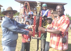 GHRA Secretary Quesi Henry (right) presents the winning Chico Singh trophy to Mangall Ramlall owner of stormy water for winning the two year race.