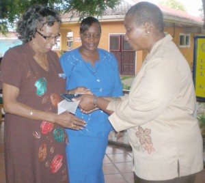 Mother’s Union Vice Presidents, Patricia Adams (left) and  June Morgan, receive the plaque from President of the Rotary  Club of Central Georgetown, Dr Heather Johnson (right).