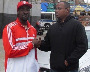 Wayne ‘Big Truck’ Braithwaite shakes hands  with former local journalist Duane Fowler in Downtown Brooklyn recently. 