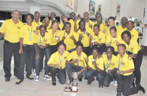 The triumphant Guyana national rugby teams pose for Kaieteur Sport shortly after  they touched down, at the Cheddi Jagan International Airport last Tuesday night. 