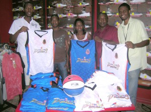 Customer Representatives of Colours Boutique, Kevin Hunte  (second, left) and Nikela Marks (third, left) present the uniforms  and other apparel to, from left, Panthers’ Yannick Wade, Head Coach Deryck Alphonso and Yannick December. 