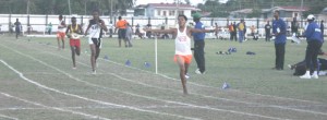 Rupununi’s Daniel Felix opens his arms in celebration as he crosses the finish line to win the Under-16 Boys’ 3000m in what should have been a schools’ record.