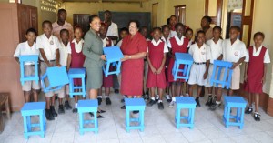 NAMILCO representative Ms. Dierdre Chan (left) makes the presentation to Head Mistress of St. Ann’s Primary Ms. Nandanie Ramoutar in the presence of students and teachers. 