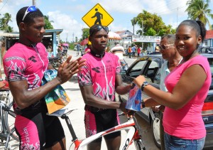 Stage winner Mario Forde (2nd left), receiving his gift from a smiling Universal Pharmacy representative. At left is 3rd place finisher Marloe Rodman while missing is Godfrey Pollydore who copped 2nd place.