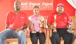 Respective top finishers Vijay Deo (right) and Christine Sukhram pose with Digicel’s CEO Gregory Dean and their trophies yesterday. 