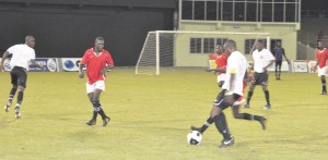 Sunburst Camptown Captain Nigel Codrington (with ball) on the attack against Riddim Squad.  At left and keeping a keen eye on things is teammate Lance Rolston. (Franklin Wilson photo)