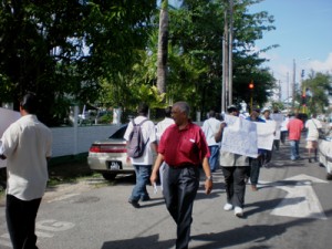  GAWU officials and sugar workers picketing the Ministry of Finance, Main Street, yesterday.