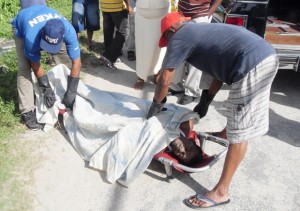 Inshan Ally’s body being covered up to be placed into a hearse.