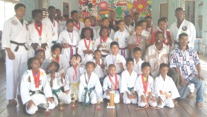 Successful participants at the Harpy Eagle Martial Arts Academy East Coast Championships pose with their hardware following the completion of the presentation ceremony. 